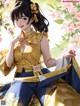 A woman in a yellow and blue kimono sitting under a tree.