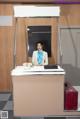 A woman sitting at a desk in an airport.